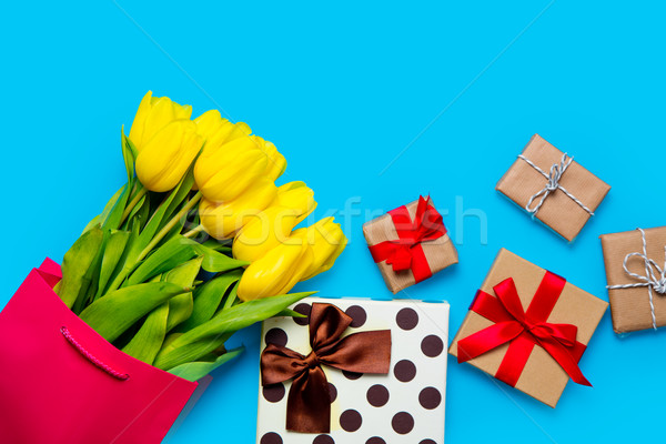 bunch of yellow tulips in cool shopping bag and cute gifts on th Stock photo © Massonforstock