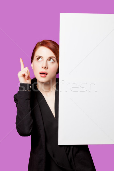 beautiful surprised young woman with big empty poster on the won Stock photo © Massonforstock