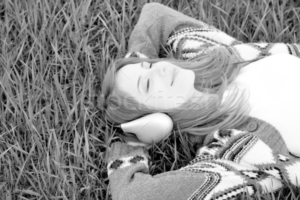 Young fashion girl with headphones lying at grass. Photo in blac Stock photo © Massonforstock