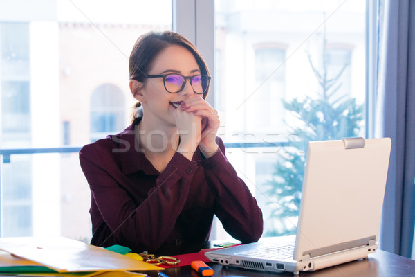 beautiful young woman sitting at the desk and thinking about som Stock photo © Massonforstock