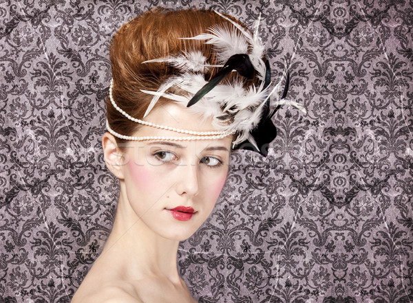 Surprised redhead girl with Rococo hair style at vintage backgro Stock photo © Massonforstock