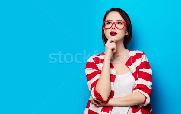 portrait of the beautiful young smiling woman on the blue backgr Stock photo © Massonforstock