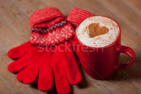 Stock photo: photo of cup of coffee and warm gloves on the wonderful brown wo