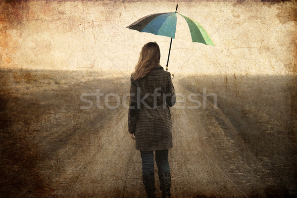 Redhead girl with umbrella at outdoor. Stock photo © Massonforstock
