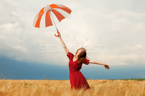 Redhead girl with umbrella at field Stock photo © Massonforstock