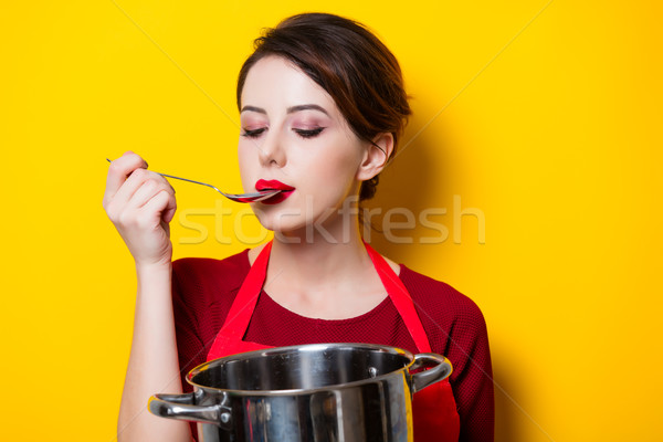 Stock photo: young housewife with pan and spoon 