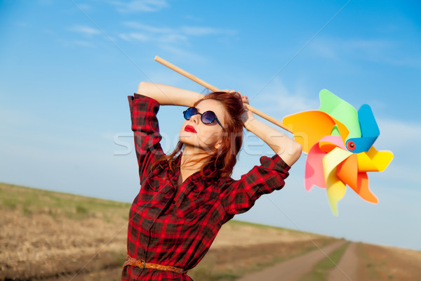 beautiful young woman with cool wind toy in the middle of the ro Stock photo © Massonforstock