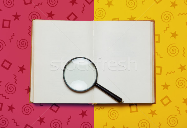 photo of opened notebook and magnifying glass on the wonderful c Stock photo © Massonforstock