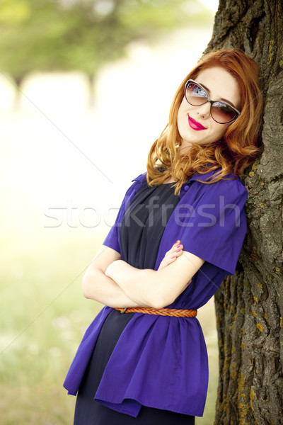 Redhead girl near tree at outdoor. Stock photo © Massonforstock