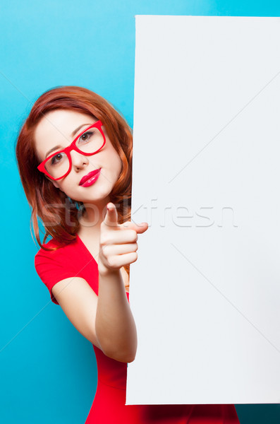 photo of beautiful young woman holding empty poster on the wonde Stock photo © Massonforstock