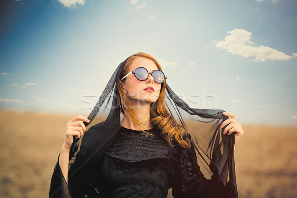 photo of beautiful young woman holding shawl on the wonderful fi Stock photo © Massonforstock