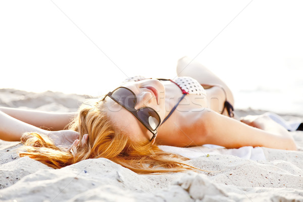 Red-head girl at the beach in sunrise. Stock photo © Massonforstock