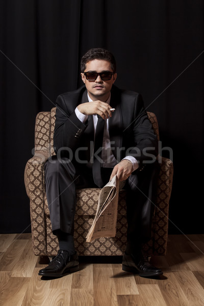 男子 香煙 報紙 坐在 復古 扶手椅 商業照片 © Massonforstock