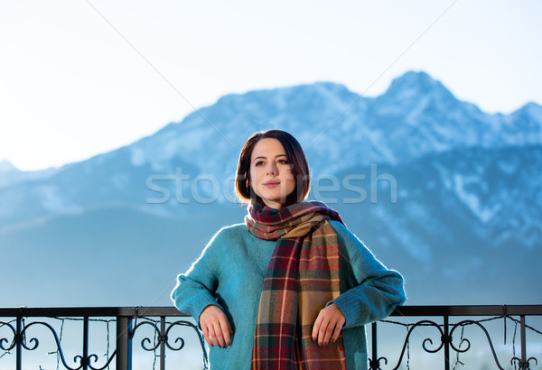 Stock photo: Portrait of a young redhead woman with mountains on background