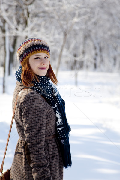 Beautiful young red-haired woman in winter park  Stock photo © Massonforstock