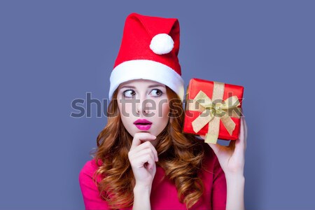 Beautiful red-haired girl with present box. Stock photo © Massonforstock