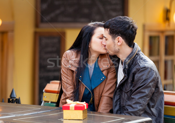 photo of cute couple sitting on the bench and kissing on the won Stock photo © Massonforstock