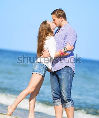 Young couple kissing at the beach. Stock photo © Massonforstock