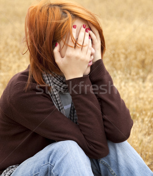 Lonely sad red-haired girl at field Stock photo © Massonforstock