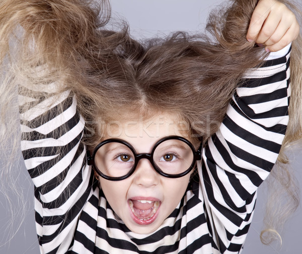 Young shouting child in glasses and striped knitted jacket. Stock photo © Massonforstock