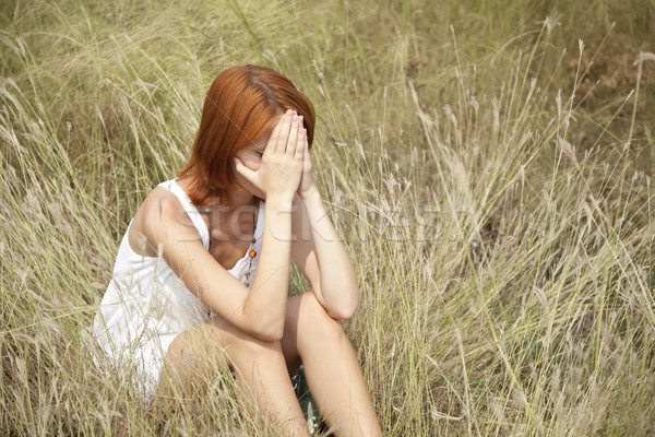 Sad red-haired girl at grass. Stock photo © Massonforstock