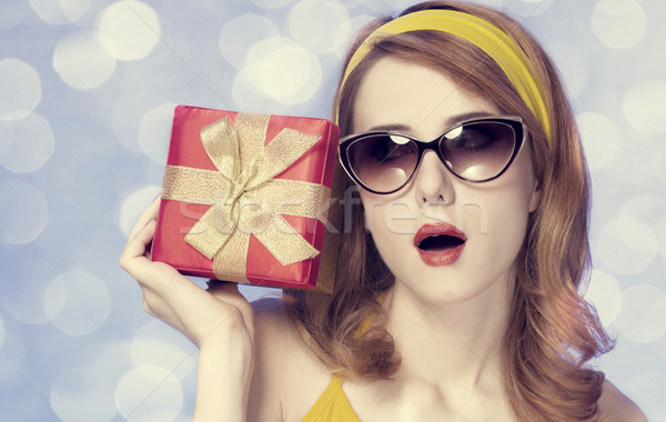 American redhead girl in sunglasses with gift. Stock photo © Massonforstock