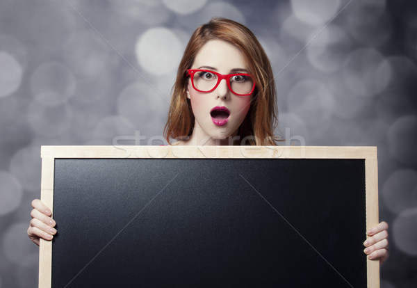 Redhead student with blackboard. Stock photo © Massonforstock