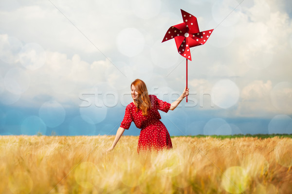 Redhead girl with toy wind turbine Stock photo © Massonforstock