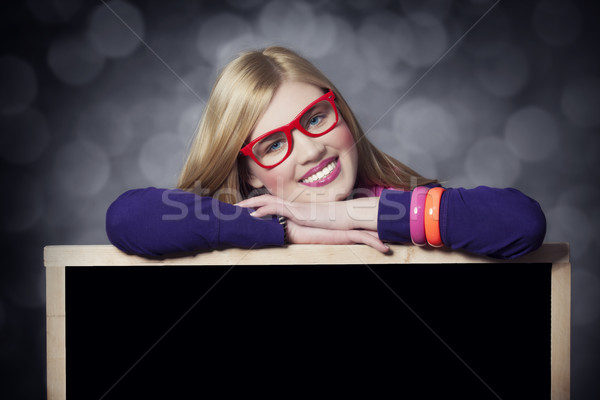 Smiling teen girl with blackboard. Stock photo © Massonforstock