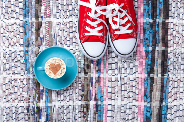 Stock photo: cup and gumshoes on the table