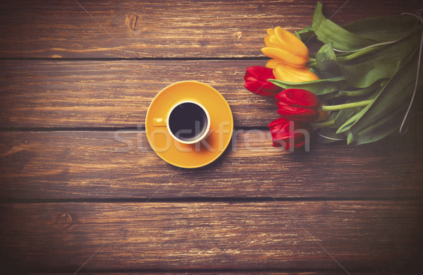 Cup of coffee and tulips on wooden table.  Stock photo © Massonforstock