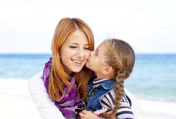 Two sisters 5 and 22 years old at the beach in sunny autumn day Stock photo © Massonforstock