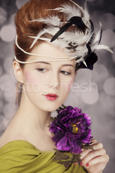 Redhead girl with Rococo hair style and flower at vintage backgr Stock photo © Massonforstock