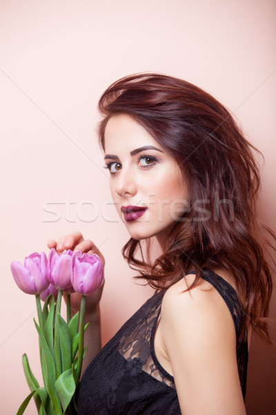 beautiful young woman with bunch of tulips on the wonderful pink Stock photo © Massonforstock