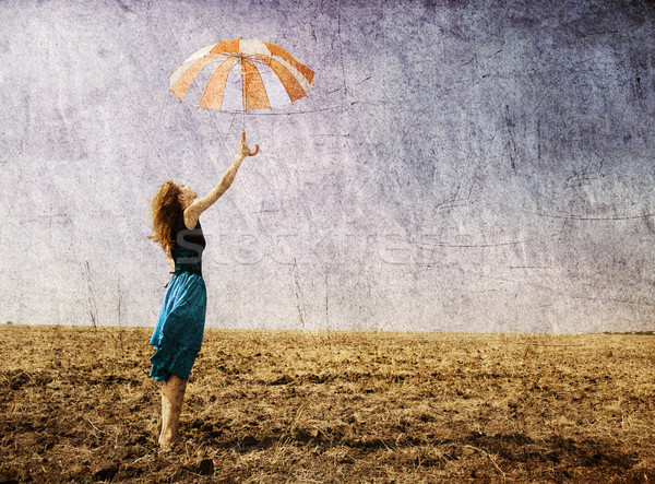 Dziewczyna parasol wietrzny trawy łące Zdjęcia stock © Massonforstock