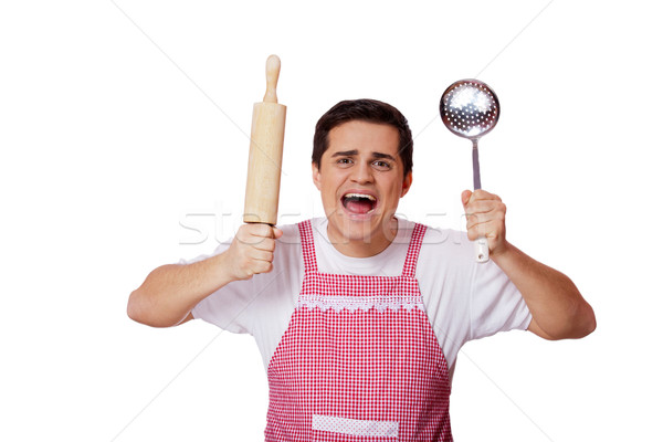 Cooking man with kitchenware over white background Stock photo © Massonforstock