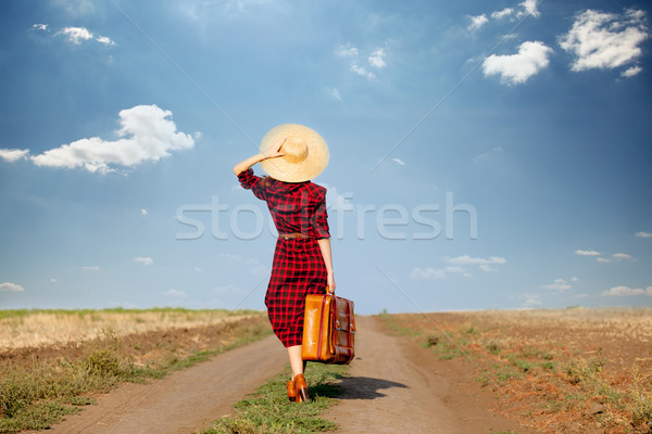 beautiful young woman with brown suitcase in the middle of the r Stock photo © Massonforstock