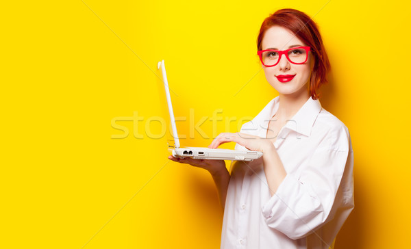 photo of beautiful young woman holding laptop on the wonderful y Stock photo © Massonforstock