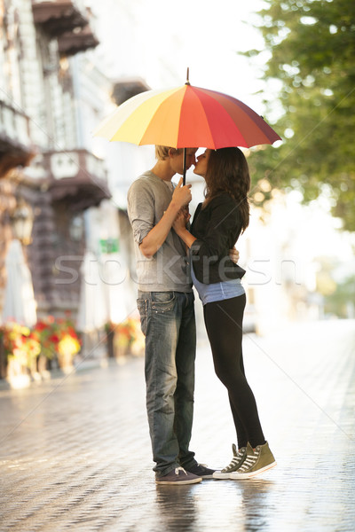 Young couple on the street of the city with umbrella Stock photo © Massonforstock