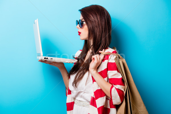 beautiful young woman with shopping bags and laptop standing in  Stock photo © Massonforstock
