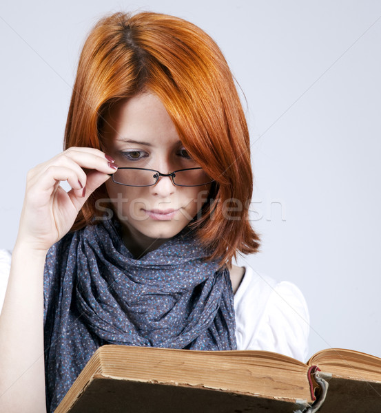 Young doubting fashion girl in glasses with old book Stock photo © Massonforstock