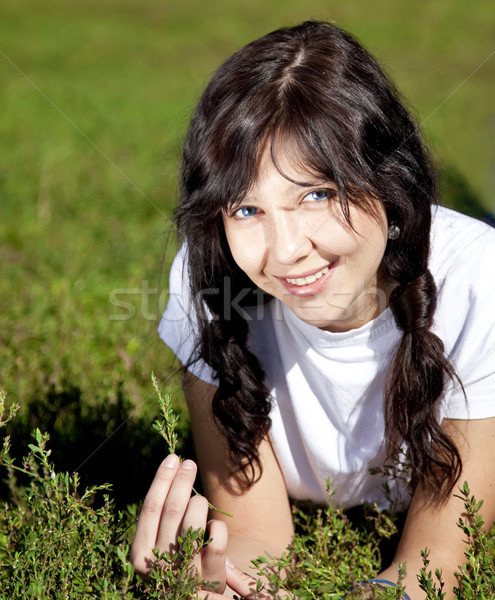 Portrait of beautiful brunette girl with blue eyes on green gras Stock photo © Massonforstock