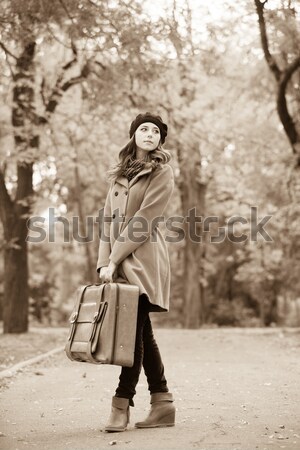 Young fashion girl with headphones sitting at spring meadow. Pho Stock photo © Massonforstock