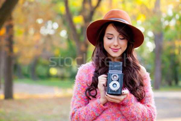 photo of beautiful young woman standing in the park with retro c Stock photo © Massonforstock