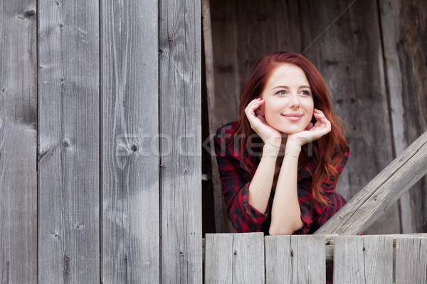 girl near a wooden wall. Stock photo © Massonforstock