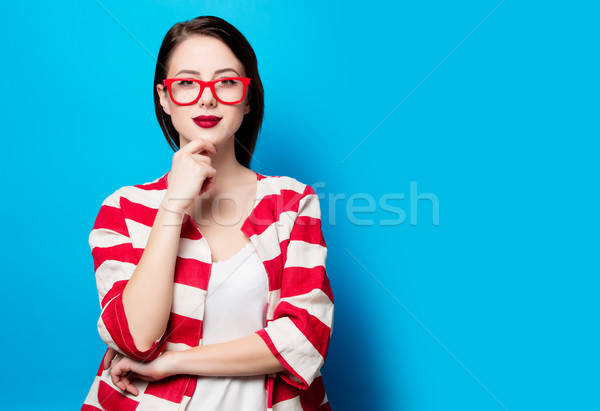 portrait of the beautiful young smiling woman on the blue backgr Stock photo © Massonforstock