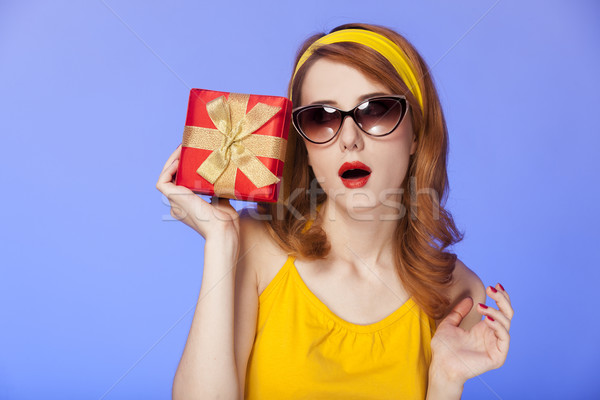American redhead girl in sunglasses with gift. Stock photo © Massonforstock