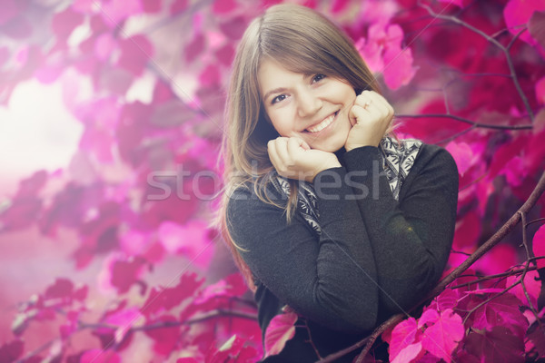 Beautiful girl at autumn park. Leafs in pink color. Stock photo © Massonforstock
