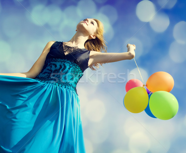 Stock photo: Redhead girl with colour balloons 