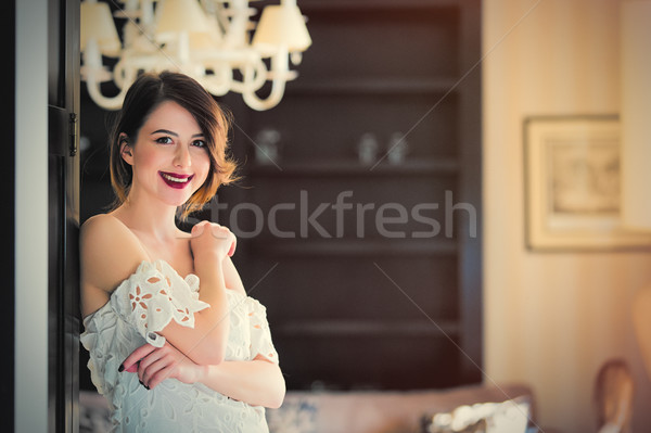 beautiful young woman standing near the door in the light luxury Stock photo © Massonforstock